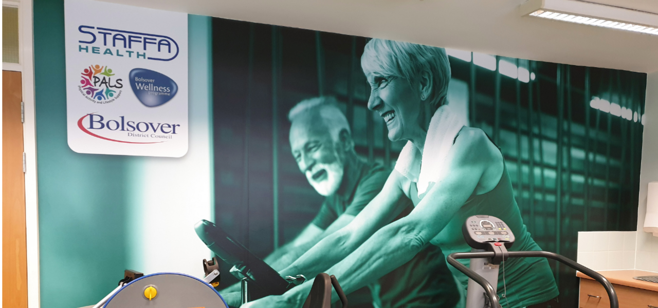 wall graphics of an elderly man and woman exercising